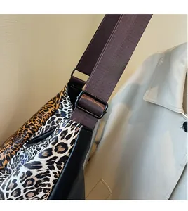 Detail of adjustable shoulder strap and dual-tone leopard print fabric on a large tote