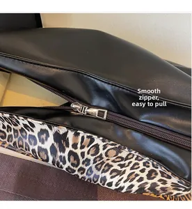 Detail of smooth metal zipper on black leather leopard print shoulder bag