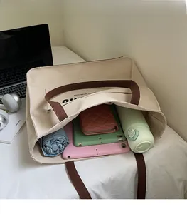 Spacious canvas tote bag interior showing capacity for tablets, wallet, and water bottle
