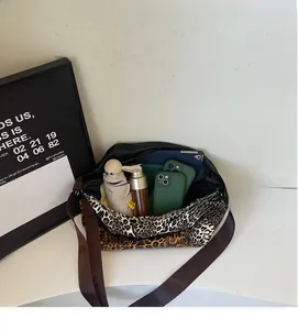 Macro shot showing large storage capacity of leopard print tote bag with daily items