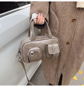 Detail of khaki PU leather crossbody bag with front zipper and flap pockets