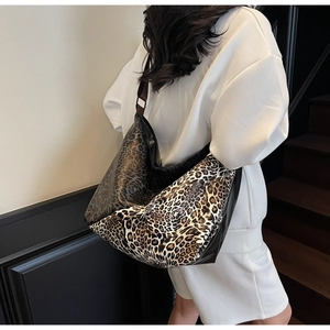 Close-up of the large leopard print hobo bag with a dark brown wide shoulder strap
