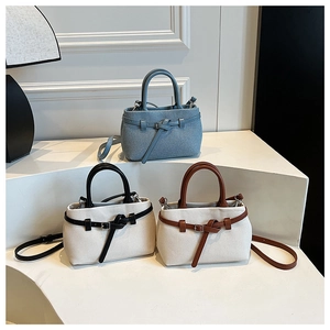 Three elegant bucket bags in woven canvas and denim textures with chic buckle details