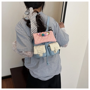 Detail of a mini quilted backpack with colorful bead handle and pastel color-block design