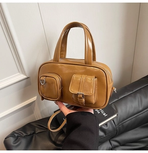 Detail of vintage caramel brown PU leather crossbody bag showing dual functional pockets