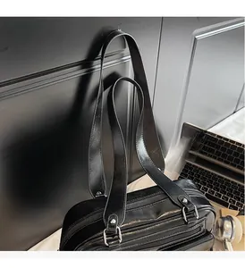 Close-up of black PU leather bowling bag showing triple zippers and silver D-ring hardware