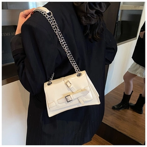 Detail of square white crossbody bag with silver buckle straps and metal chain strap