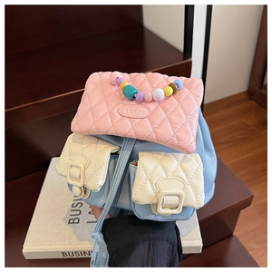 Detail of macaron-colored quilted mini backpack with beaded handle and double pockets