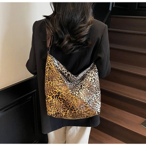 Detail of large leopard print tote bag with color-block patterns and brown wide shoulder strap