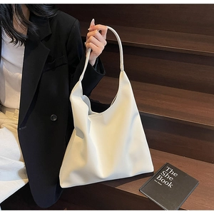 Minimalist large white PU leather hobo tote bag shown in a professional lifestyle setting