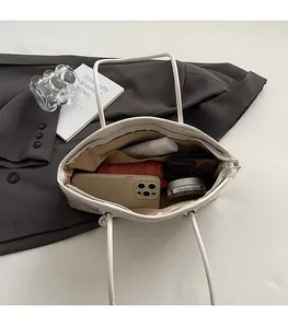 Top view showing spacious interior with zipper pocket in off-white leather tote bag