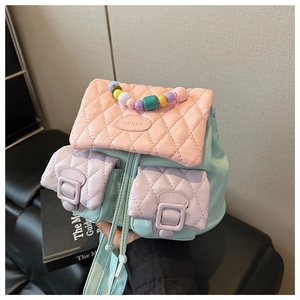 Detail of macaron color block quilted backpack with pearl handle and drawstring closure
