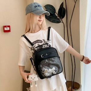 Détail d'un sac Ita noir avec une grande fenêtre transparente et un nœud décoratif blanc