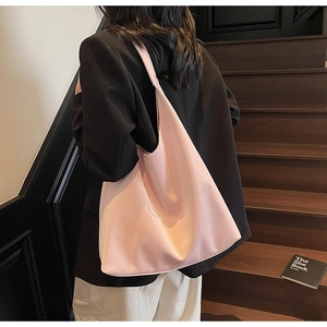 Detail of light pink large tote bag in soft leather texture shown on model back