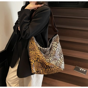 Detail of large leopard print tote bag with contrast stitching and wide shoulder strap