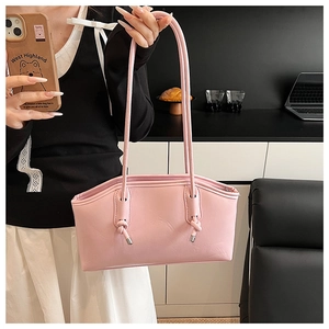 Close-up of pink PU leather tote bag with long shoulder straps and knot details