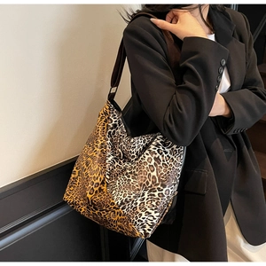 Detailed close-up of leopard print texture and stitching on a large tote bag