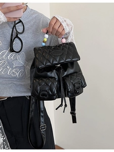 Quilted black mini backpack featuring elegant colorful beaded handle and Lulu logo