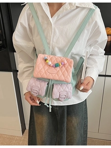 Multicolor pastel accordion backpack with diamond quilting and decorative beaded handle