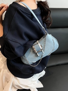 Light blue denim shoulder bag with vintage frayed edges and metal buckle detailing