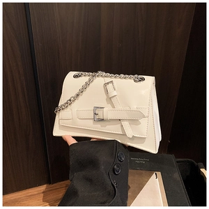 Detailed shot of white geometric crossbody bag featuring glossy PU and silver chain straps