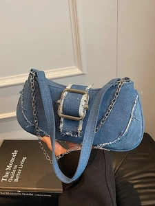 Denim underarm bag with frayed edges and oversized silver buckle for a street style look