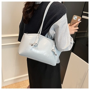 Gray-blue glossy leather tote bag with knotted strap detail shown on a shoulder