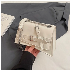 Detail showing white leather chain shoulder bag with double buckle and silver hardware