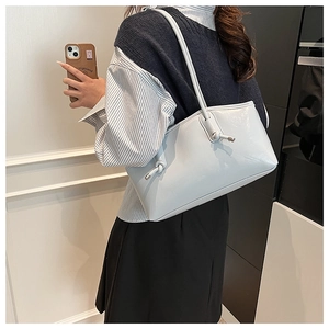 Detail showing the light blue PU shoulder bag with unique knot design on the strap