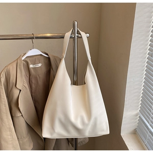 Detail view of large white minimalist tote bag in matte PU leather for daily commuting