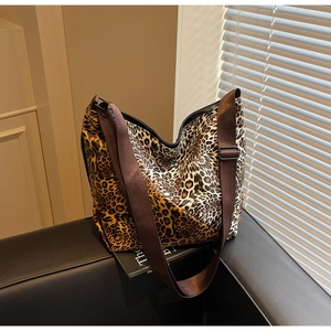 Detail of hobo bag featuring leopard print, wide brown strap and a large interior capacity