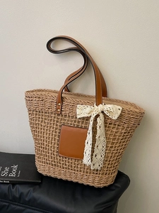 Large straw tote bag with leather handles and lace bow decoration for summer beach travel