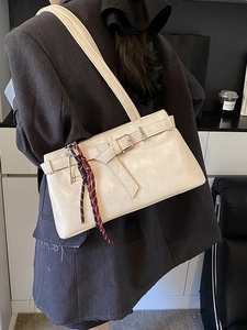 Chic beige underarm bag with decorative belt buckle and red plaid silk scarf accessory