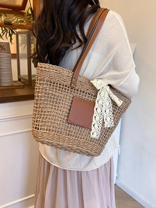 Handwoven straw tote bag with leather logo and lace bow for summer beach vacation