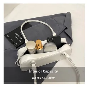 Detail shot of white shoulder bag interior storage for phone and cosmetics
