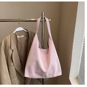 Pink minimalist large capacity tote bag shown hanging with a casual blazer outfit