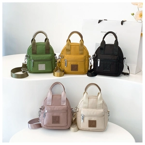 Close-up of lightweight waterproof nylon crossbody bags in five assorted colors