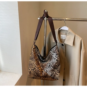 Detail of large leopard print hobo bag with durable wide shoulder strap and metal ring