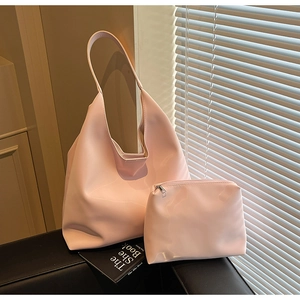 Close-up of pink hobo tote bag and matching small pouch set in glossy faux leather