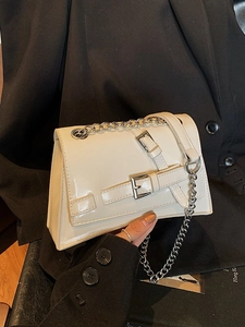 Glossy white box shoulder bag with silver buckle details and metallic chain strap