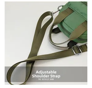 Detail of adjustable nylon strap and silver-tone hardware on the green crossbody bag