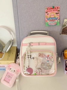 Sac à dos ita blanc et rose avec grande fenêtre transparente et breloque mélodie