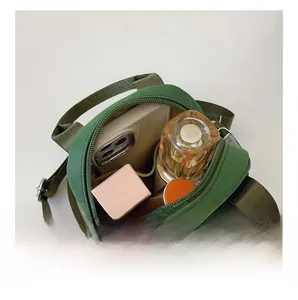 Macro view of compact nylon crossbody bag with internal storage for phone and cosmetics