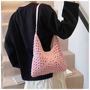 Pink woven hollow tote bag with diamond pattern shown on model in casual scene