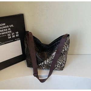 Detail view of large leopard print tote bag with adjustable nylon shoulder strap