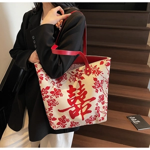 Detail of red wedding tote bag featuring a traditional double happiness jacquard design