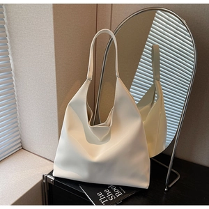 Macro shot of minimalist cream white matte leather tote bag with wide shoulder strap