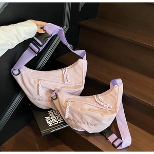 Detail of light purple nylon moon bags in two sizes with woven zip pulls and straps