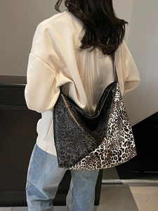 Large leopard print tote bag in dual-tone拼接 design worn by model from behind