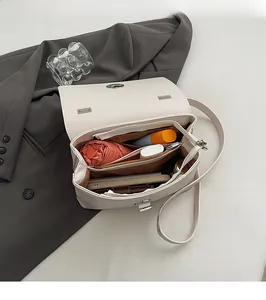 Interior view of cream PU leather crossbody bag showing large capacity for essentials